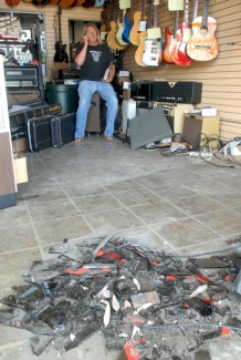 van crashes into guitar repair shop